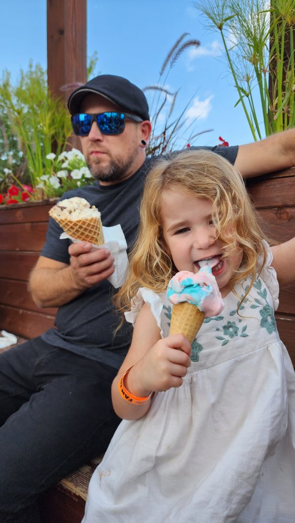 Father and daughter eating ice cream in downtown Eau Claire, Wisconsin.