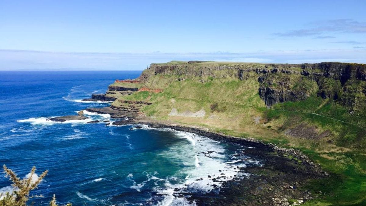 The stunning Irish cliffs with the ocean waves crashing onto the shore.