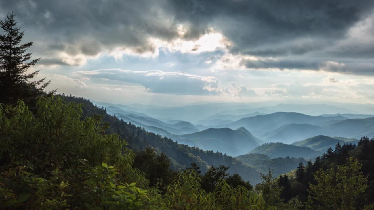 The majestic and mystical Blue Ridge Mountains shrouded in fog. Featured image for Blowing Rock Travel Guide.
