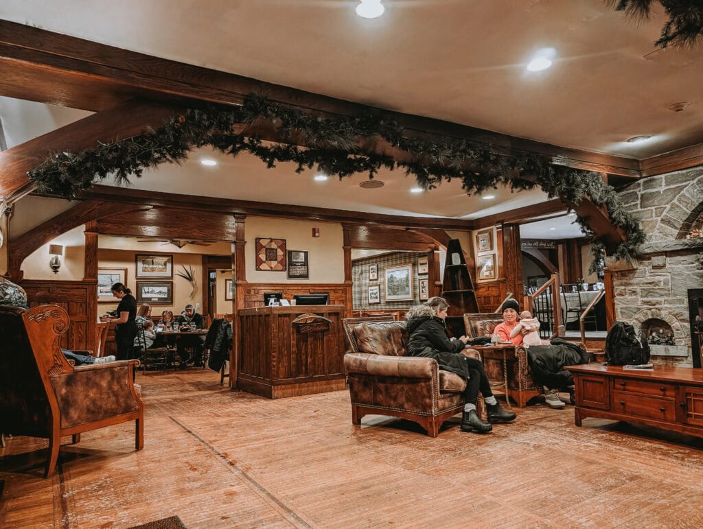Timberlake’s Restaurant inside Chetola Lodge offers a warm, rustic lounge area with leather seating and soft lighting, ideal for relaxing before a meal.