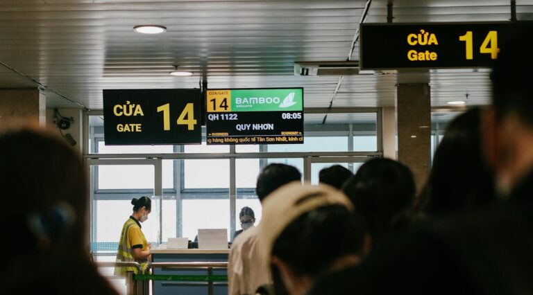People standing in line at an airport gate, waiting to board a flight.